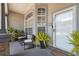 Cozy front porch with seating, plants, and a clear view of the entrance at 7903 Lake Placid Ln, Trinity, FL 34655