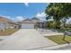 Charming home with an attached two-car garage and mature tree at 7903 Lake Placid Ln, Trinity, FL 34655