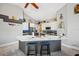 Stylish kitchen featuring gray and white cabinetry, granite countertops, and a wine rack at 7903 Lake Placid Ln, Trinity, FL 34655