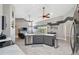 Open-concept kitchen with stainless steel appliances, a large island, and views of the dining area at 7903 Lake Placid Ln, Trinity, FL 34655