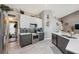 Modern kitchen with stainless appliances, sleek cabinets, and open design to living space at 7903 Lake Placid Ln, Trinity, FL 34655