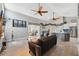 Spacious living room with two ceiling fans seamlessly connects to dining and kitchen area at 7903 Lake Placid Ln, Trinity, FL 34655