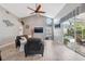Open-concept living room with vaulted ceiling, tile flooring, and a view of the pool area at 7903 Lake Placid Ln, Trinity, FL 34655