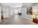 Open-concept living room featuring tile floors, chandelier, and neutral paint at 7903 Lake Placid Ln, Trinity, FL 34655