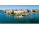 Stunning aerial view of waterfront community with pristine landscaping and calm waters at 8000 Sailboat Key S Blvd # 202, St Pete Beach, FL 33707
