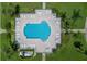 Aerial of community pool, surrounded by lounge chairs and manicured greenery at 8000 Sailboat Key S Blvd # 202, St Pete Beach, FL 33707