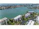Wide aerial view of a waterfront condo complex with surrounding waterways and cityscape at 8000 Sailboat Key S Blvd # 202, St Pete Beach, FL 33707