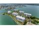 Breathtaking aerial view of waterfront condos with lush landscaping and stunning water views at 8000 Sailboat Key S Blvd # 202, St Pete Beach, FL 33707