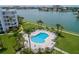 Relaxing community pool with chairs and tables overlooking the bay at 8000 Sailboat Key S Blvd # 202, St Pete Beach, FL 33707