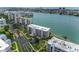 Beautiful waterfront condo building with manicured landscaping and serene water views at 8000 Sailboat Key S Blvd # 202, St Pete Beach, FL 33707
