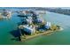 Gorgeous aerial view of a coastal community with condo buildings and a pool at 8000 Sailboat Key S Blvd # 202, St Pete Beach, FL 33707