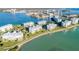Wide aerial shot of waterfront condos, showcasing beach access and lush landscaping at 8000 Sailboat Key S Blvd # 202, St Pete Beach, FL 33707