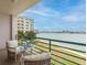 Relaxing balcony with seating and a view of the water and landscaped grounds at 8000 Sailboat Key S Blvd # 202, St Pete Beach, FL 33707