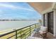 Balcony with seating overlooking the bay, offering stunning waterfront views and a relaxing outdoor space at 8000 Sailboat Key S Blvd # 202, St Pete Beach, FL 33707