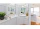 Bright bathroom features a corner vanity with a mirrored wall and stylish decor at 8000 Sailboat Key S Blvd # 202, St Pete Beach, FL 33707