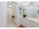 Clean bathroom featuring a glass-enclosed shower, ample cabinet space, and modern fixtures at 8000 Sailboat Key S Blvd # 202, St Pete Beach, FL 33707