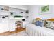 A well-appointed bedroom featuring custom built-in shelving and a comfortable daybed at 8000 Sailboat Key S Blvd # 202, St Pete Beach, FL 33707