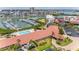 Overhead view of clubhouse with pool, marina, and well-manicured lawns at 8000 Sailboat Key S Blvd # 202, St Pete Beach, FL 33707
