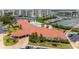 Elevated view of community clubhouse and pool surrounded by lush landscaping and nearby marina at 8000 Sailboat Key S Blvd # 202, St Pete Beach, FL 33707