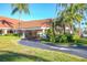 Elegant community center entrance with a covered walkway and lush landscaping at 8000 Sailboat Key S Blvd # 202, St Pete Beach, FL 33707