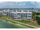 Exterior shot showcasing multi-story waterfront condo building with a coastal vibe at 8000 Sailboat Key S Blvd # 202, St Pete Beach, FL 33707