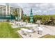 Outdoor grilling area featuring multiple grills, tables, and benches, perfect for entertaining at 8000 Sailboat Key S Blvd # 202, St Pete Beach, FL 33707