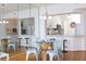 Modern open kitchen with white cabinets, stainless appliances, and a view into the dining room at 8000 Sailboat Key S Blvd # 202, St Pete Beach, FL 33707
