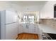 Spacious kitchen featuring white cabinets, stainless steel appliances, and a view of the living area at 8000 Sailboat Key S Blvd # 202, St Pete Beach, FL 33707