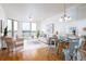 Bright living room with water view, light colored furniture, and a dining area, creating an inviting space at 8000 Sailboat Key S Blvd # 202, St Pete Beach, FL 33707