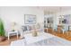 Bright living room featuring modern decor, hardwood floors, and an open layout into the kitchen at 8000 Sailboat Key S Blvd # 202, St Pete Beach, FL 33707