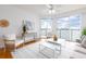 Bright living room with a beautiful water view, complemented by white furniture and decor at 8000 Sailboat Key S Blvd # 202, St Pete Beach, FL 33707