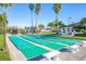 Active shuffleboard courts surrounded by benches and greenery under the Florida sun at 8000 Sailboat Key S Blvd # 202, St Pete Beach, FL 33707