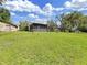 Expansive backyard featuring an in-ground pool, screened-in patio, and lush greenery at 8124 Golf Club Ct, Hudson, FL 34667