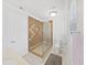 Bathroom featuring a frameless glass shower, decorative brown tile, white toilet, and a neutral floor at 8124 Golf Club Ct, Hudson, FL 34667