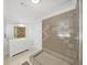 Bright bathroom with a large, walk-in shower, a white vanity, decorative brown tile, and neutral flooring at 8124 Golf Club Ct, Hudson, FL 34667