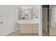 Bright bathroom featuring a single sink vanity with great lighting and large mirror at 8124 Golf Club Ct, Hudson, FL 34667