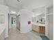 Expansive bathroom with dual sinks, walk-in shower, and access to the pool area through sliding glass doors at 8124 Golf Club Ct, Hudson, FL 34667