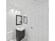Clean, minimalist bathroom featuring a single-sink vanity and a door; small and brightly lit at 8124 Golf Club Ct, Hudson, FL 34667