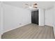 Modern bedroom with hardwood floors, neutral gray walls, and a fan, creating a comfortable space at 8124 Golf Club Ct, Hudson, FL 34667
