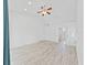 Spacious bedroom with bright white walls, wood floors, a ceiling fan, and an ensuite bathroom at 8124 Golf Club Ct, Hudson, FL 34667