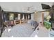 Open bedroom with a home office area, multiple windows, ceiling fans, and light wood-look flooring at 8124 Golf Club Ct, Hudson, FL 34667