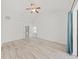 Large bedroom featuring white walls, wood floors, a ceiling fan and an ensuite bathroom at 8124 Golf Club Ct, Hudson, FL 34667