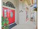 Elegant red front door with decorative glass and sidelights, complemented by plants and architectural accents at 8124 Golf Club Ct, Hudson, FL 34667