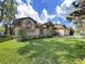 Beautiful front lawn and landscaping highlighting the architectural details of this charming single-story home at 8124 Golf Club Ct, Hudson, FL 34667