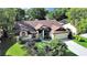 Charming single-story home featuring a well-manicured lawn and mature trees in a serene neighborhood at 8124 Golf Club Ct, Hudson, FL 34667