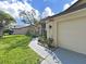 View of home exterior, highlighting the front facade, attached garage, and landscaped walkway at 8124 Golf Club Ct, Hudson, FL 34667