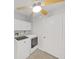 Efficient laundry room with modern washer and dryer and ample lighting, plus neutral floor tile at 8124 Golf Club Ct, Hudson, FL 34667