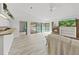 Living room with modern floors, fireplace, and access to the outdoor pool area at 8124 Golf Club Ct, Hudson, FL 34667
