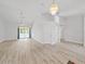 Spacious living room with vaulted ceilings, stylish light fixture, and doors that view the pool at 8124 Golf Club Ct, Hudson, FL 34667