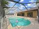 Inviting in-ground pool surrounded by a screened enclosure and patio area for outdoor enjoyment at 8124 Golf Club Ct, Hudson, FL 34667